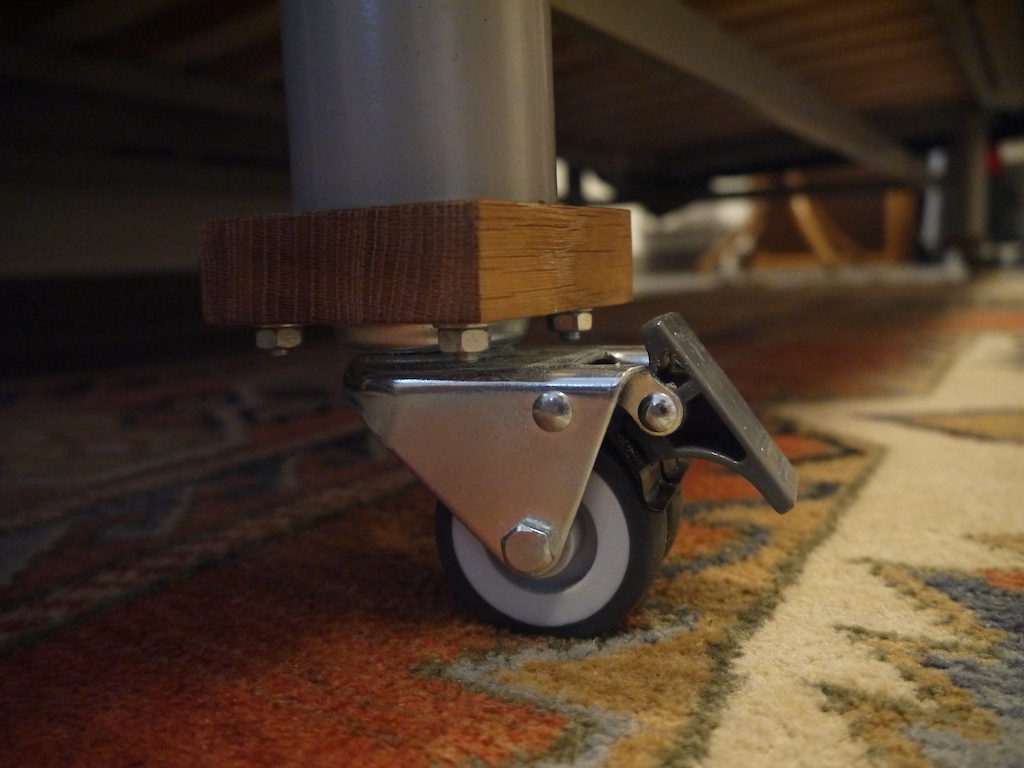 Underside of a sofa with caster wheels