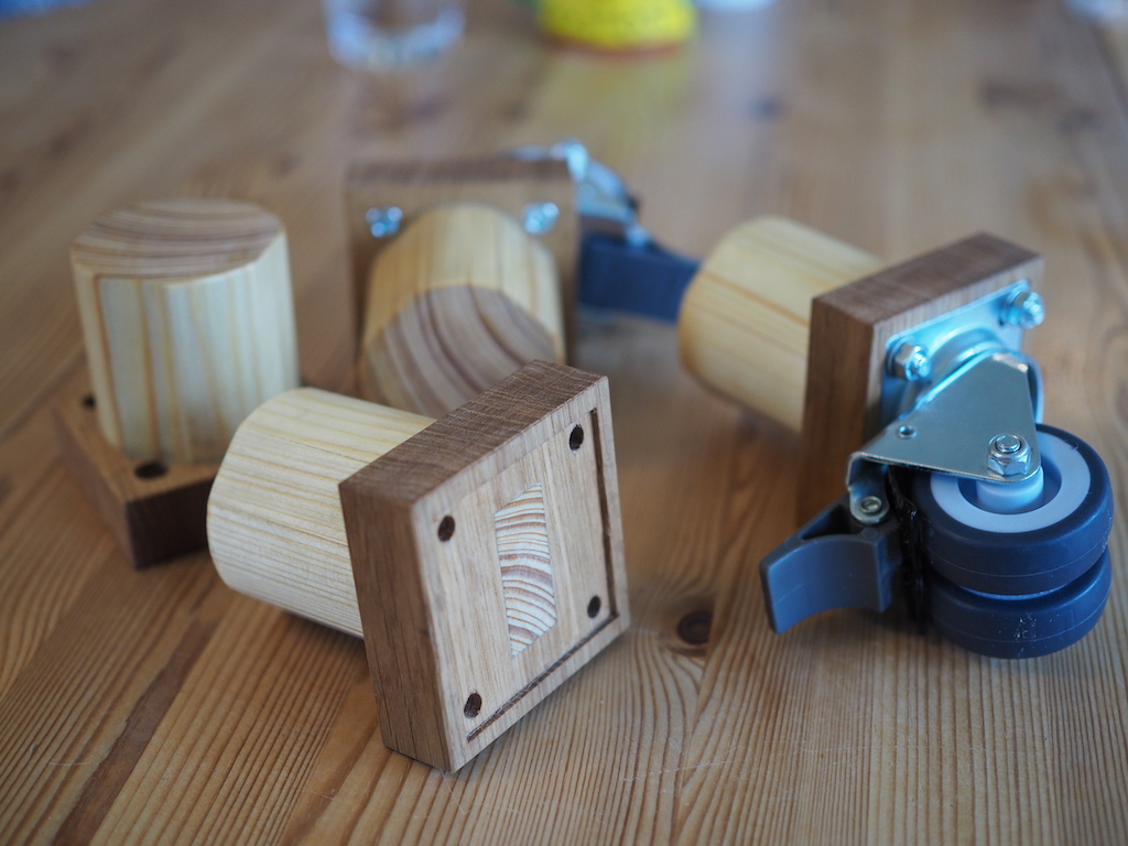 Frame inserts for mounting caster wheels onto a sofa lying on a table