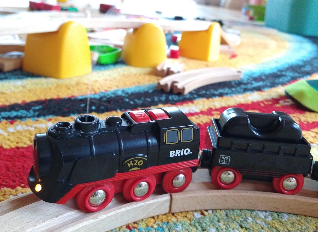 Picture of a BRIO battery steam train with a small, hard to see puff of smoke coming out of the chimney